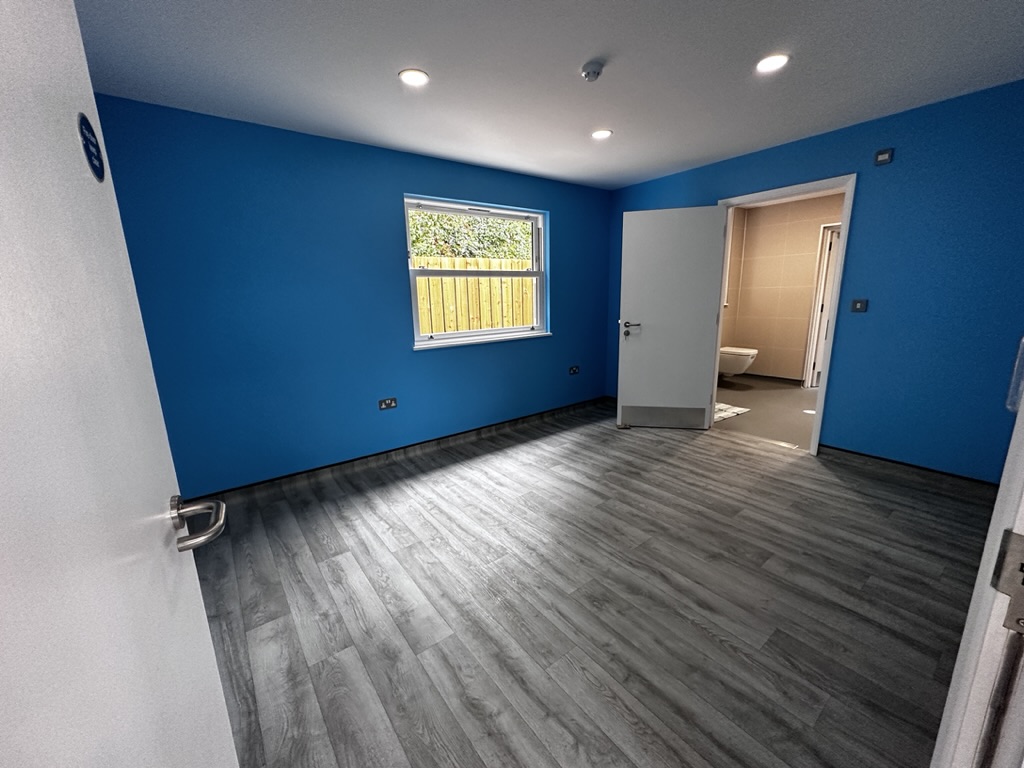 Blue bedroom with an adjoining bathroom