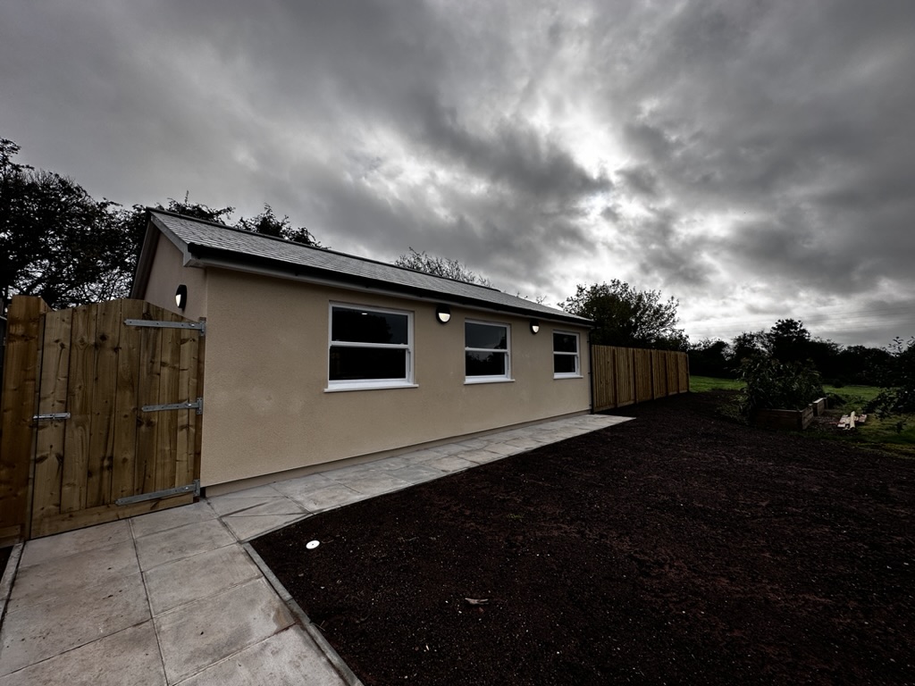 Bungalow entrance and paved approach