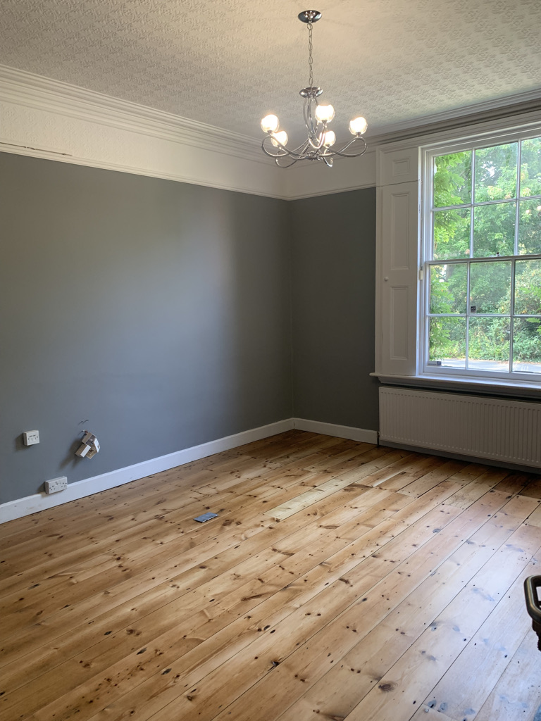 Redecorated room with timber flooring